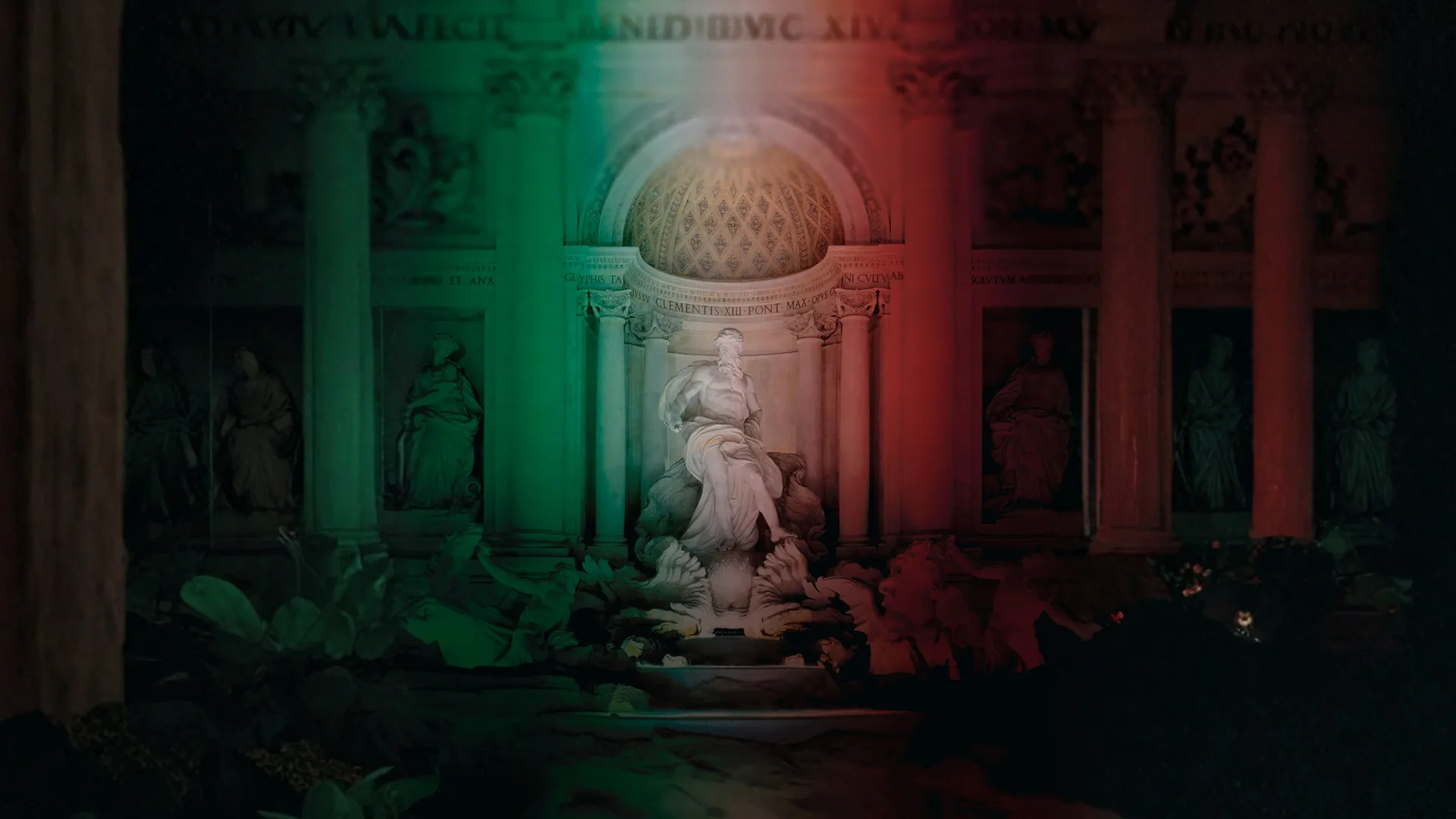 Estátua de Netuno na Fontana di Trevi, à noite, iluminada em verde, branco e vermelho